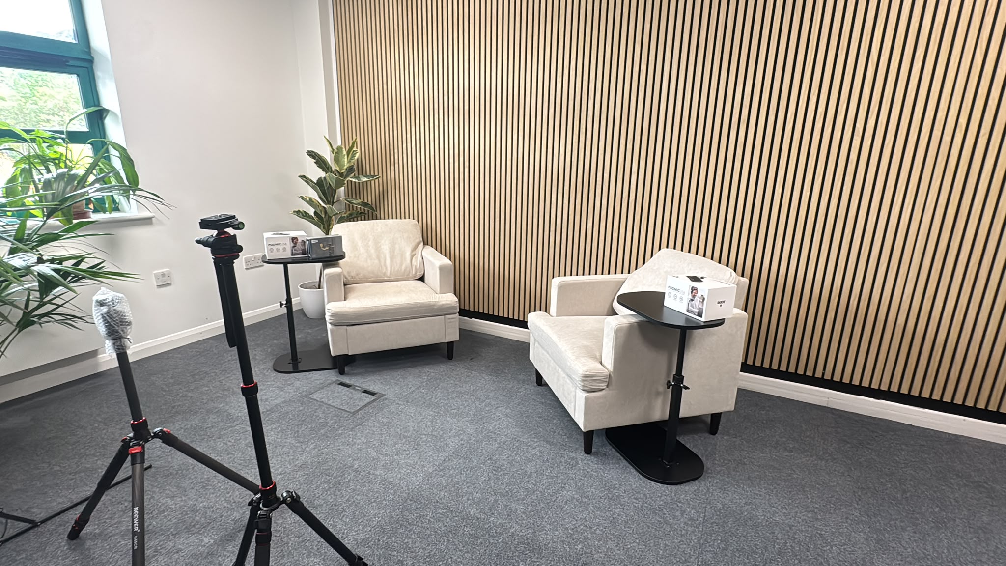 Setting up the studio with microphones and camera tripods